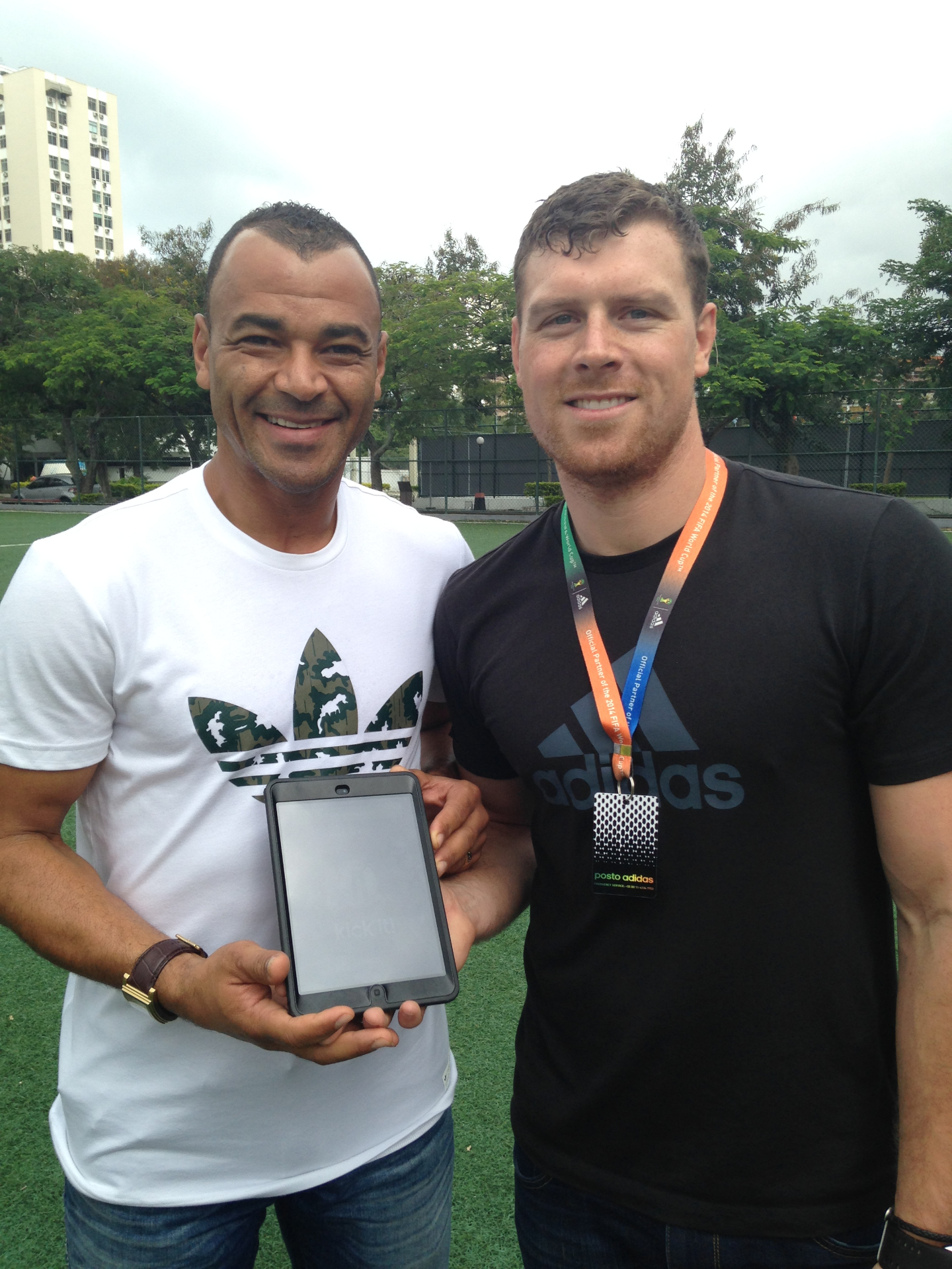 Matt Hymers on the ground with Cafu in Rio during the 2014 FIFA World Cup adidas miCoach activation
